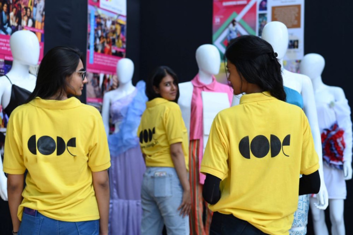 CODE students at exhibition with mannequin displays
