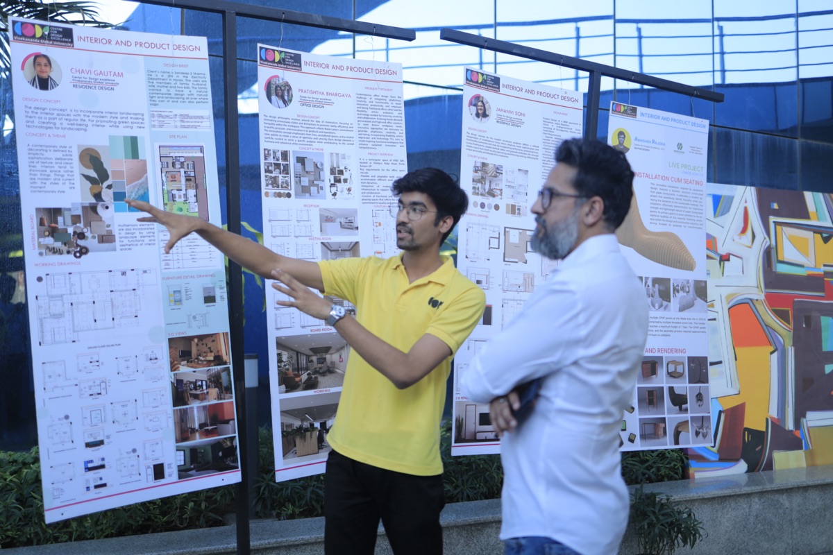 Student presenting project boards to faculty at CODE